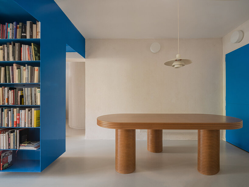 floating blue bookshelf centers BURR's conversion project in madrid