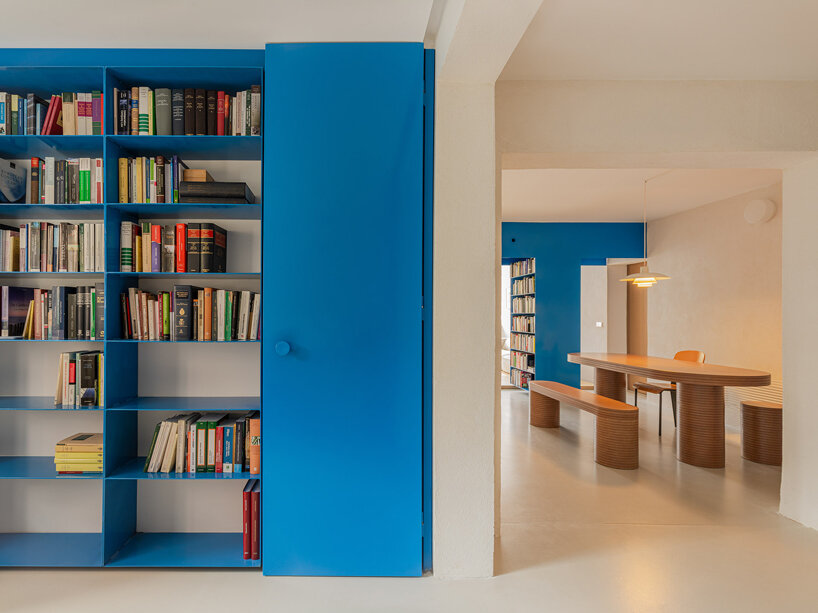 floating blue bookshelf centers BURR's conversion project in madrid