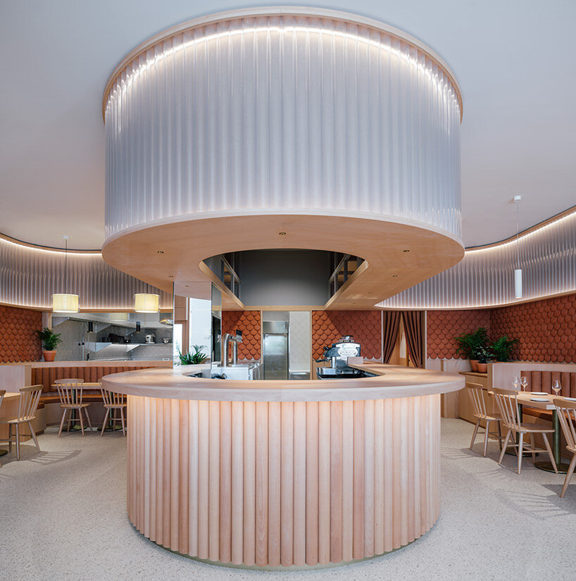 zooco estudio wraps restaurant interior in spain with clay scales and semi-transparent pipes