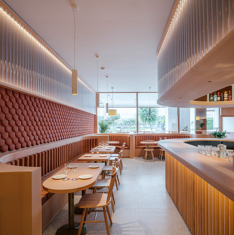 zooco estudio wraps restaurant interior in spain with clay scales and semi-transparent pipes