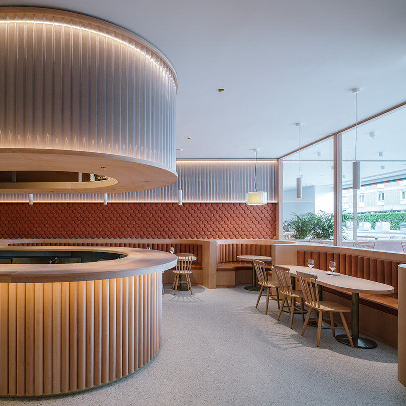 zooco estudio wraps restaurant interior in spain with clay scales and semi-transparent pipes