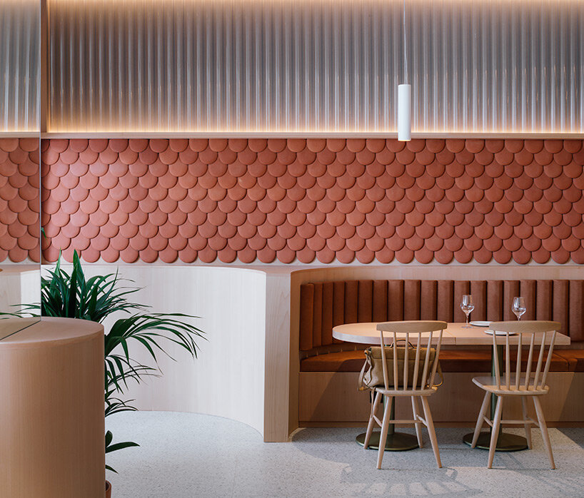 zooco estudio wraps restaurant interior in spain with clay scales and semi-transparent pipes