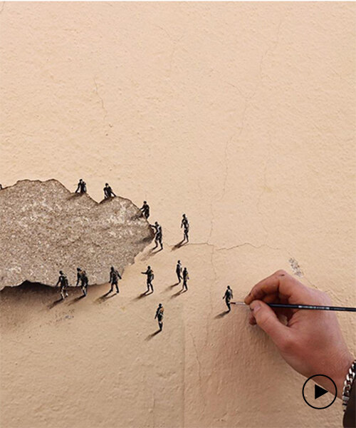 tiny figures by urban artist pejac emerge from the cracks of peeling wall in madrid