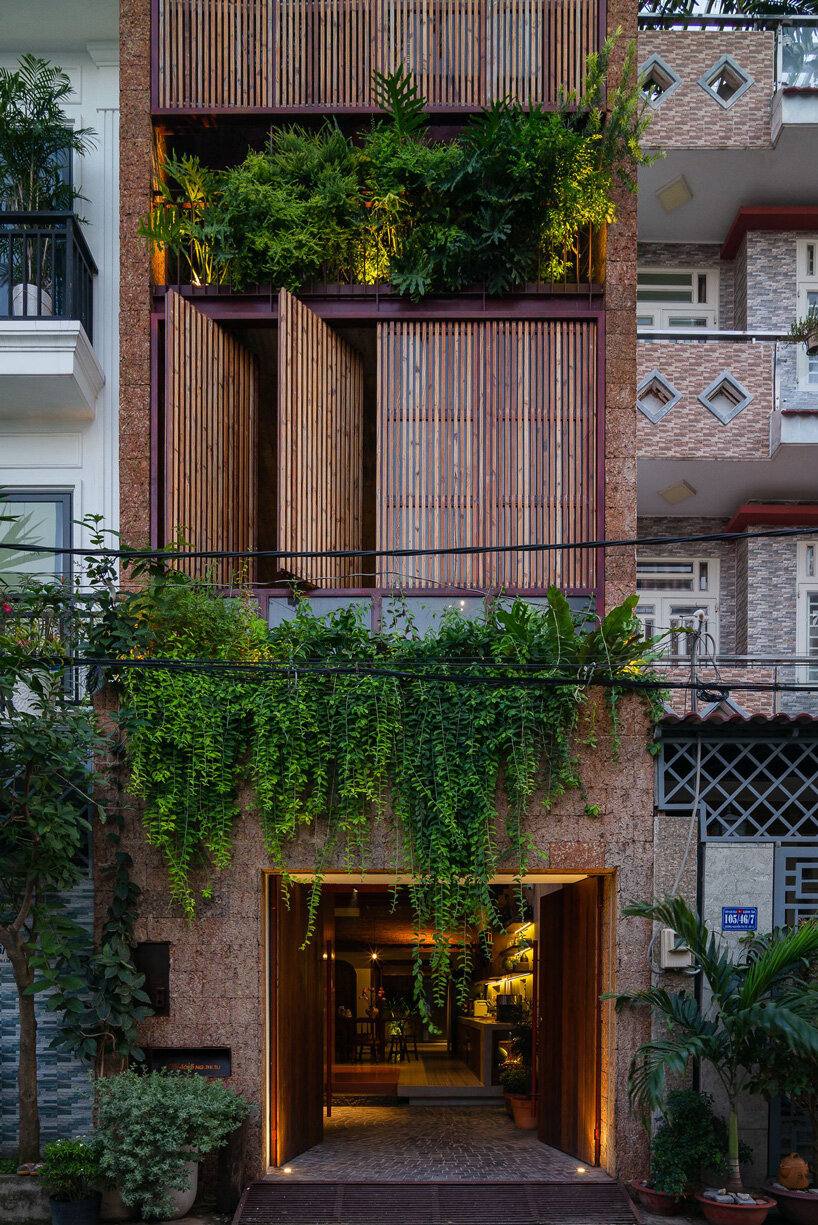 revolving wooden shutters clad the facade of AD9 architects' H house in vietnam
