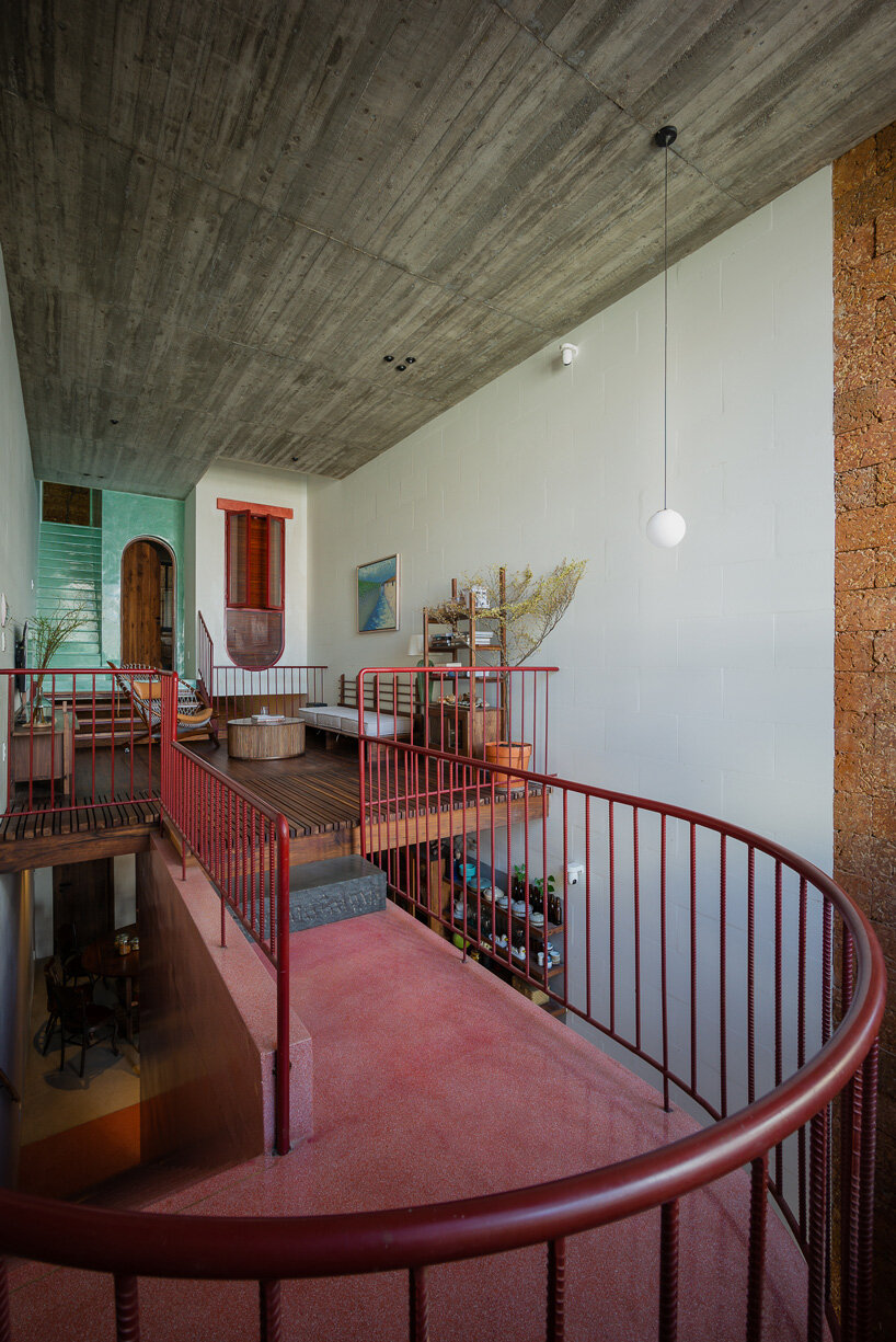 revolving wooden shutters clad the facade of AD9 architects' H house in vietnam