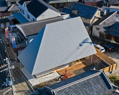 hamada design tops japanese house with rhombus-patterned galvalume roof