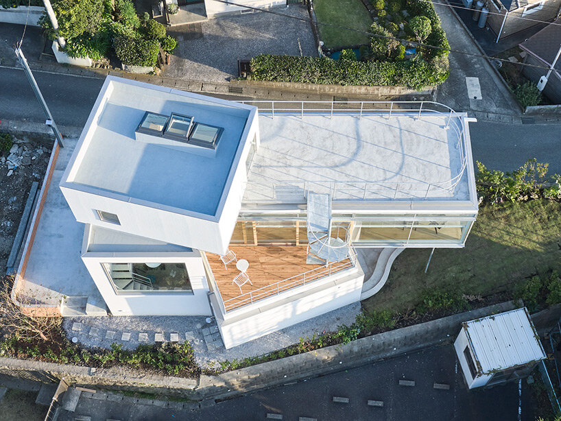 a pile of overlapping white volumes forms sunlit residence by shogo onodera in japan