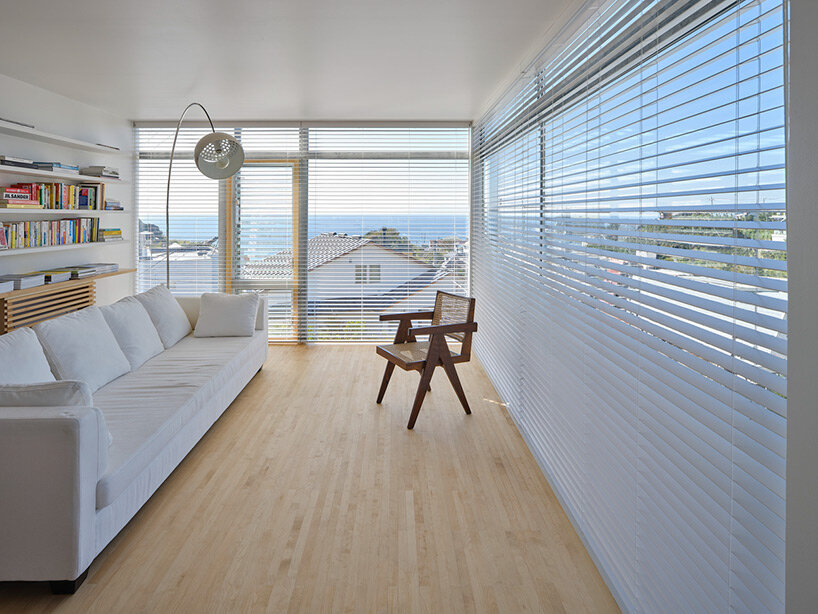 a pile of overlapping white volumes forms sunlit residence by shogo onodera in japan