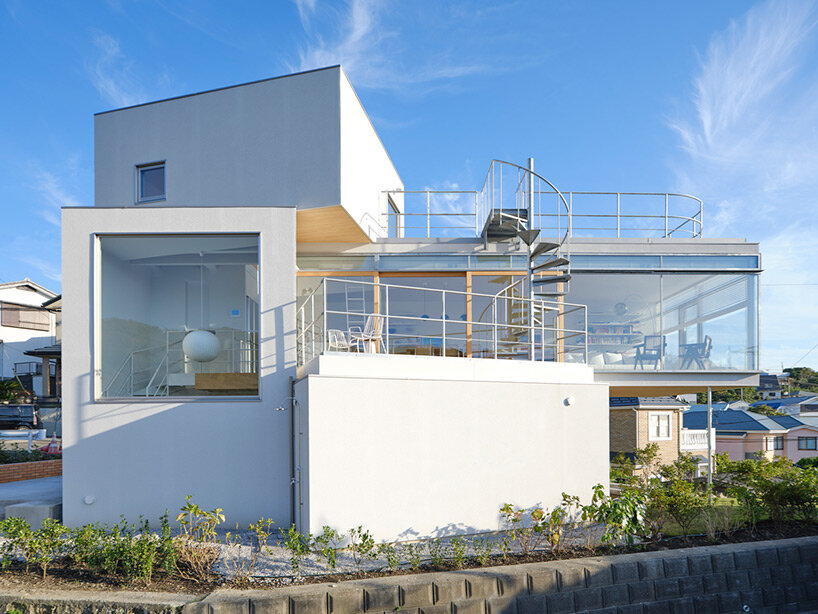 a pile of overlapping white volumes forms sunlit residence by shogo onodera in japan