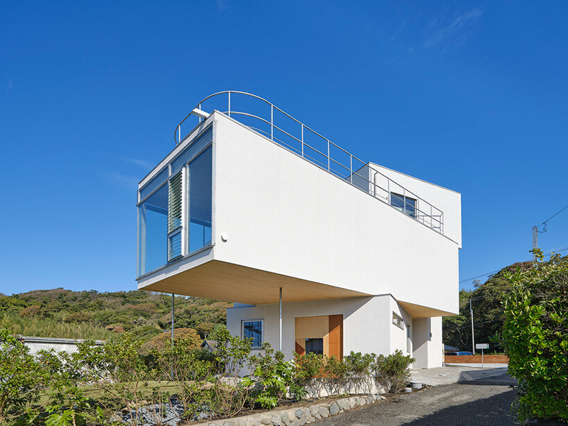 a pile of overlapping white volumes forms sunlit residence by shogo onodera in japan