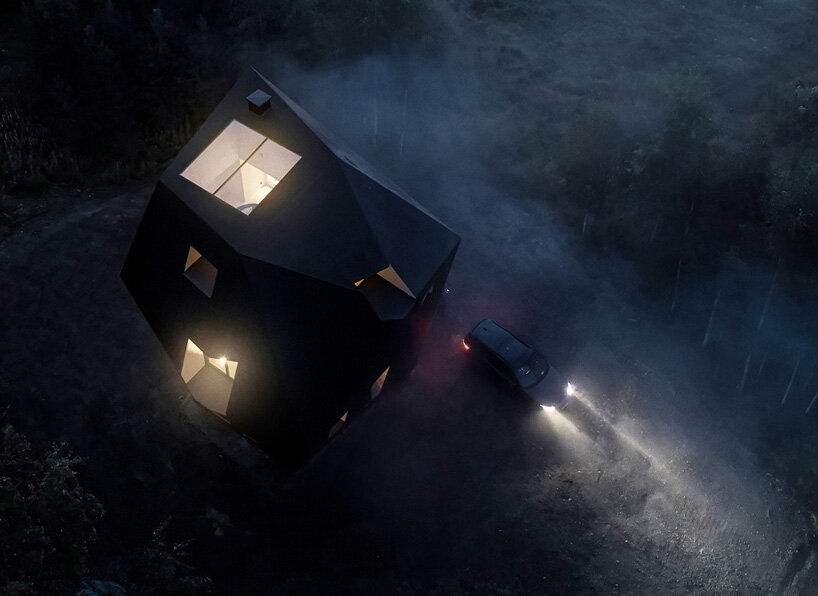 ateljé sotamaa's 'meteorite' residence emerges as a mystical dark object in finland