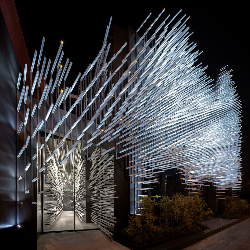 layered aluminum strips evoke dandelion seeds for this museum façade in bangkok