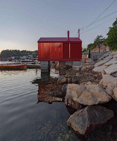 red-painted wooden cladding envelops tiny boathouse by handegård arkitektur in norway