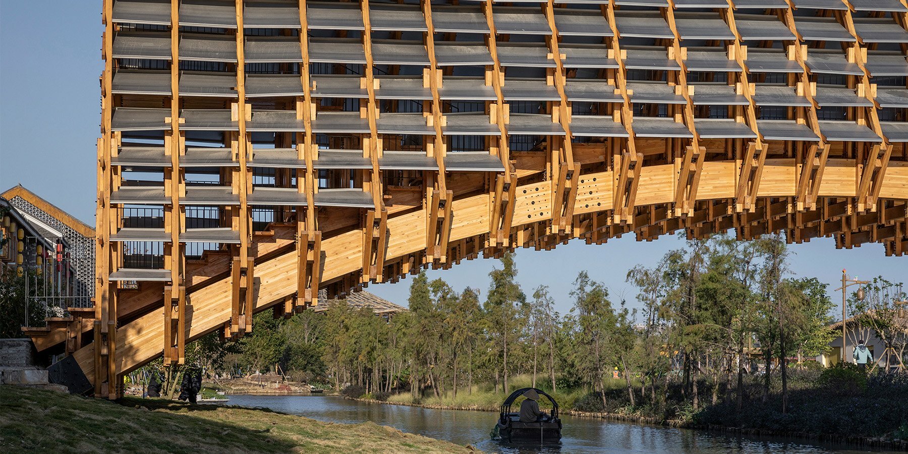 LUO studio extrudes arched timber bridge in china to revitalize