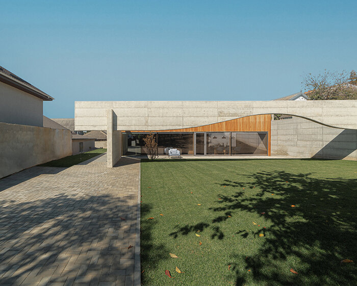 maxim calujac frames wooden villa in moldova with sculptural concrete beam