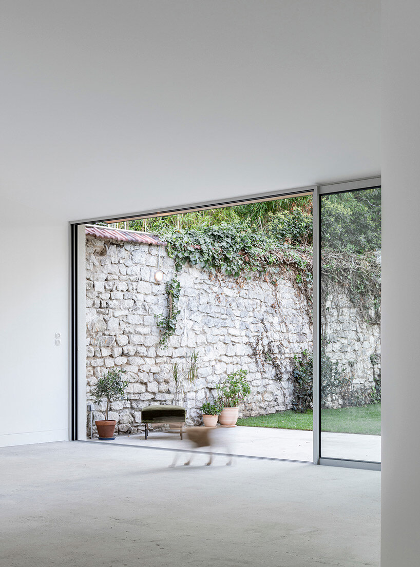 lines & curves engage in visual play within berenice curt's minimalist renovation in france