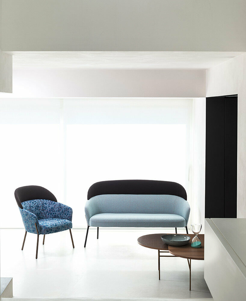 bross' expanded lounge system pairs woodwork with enveloping upholstery