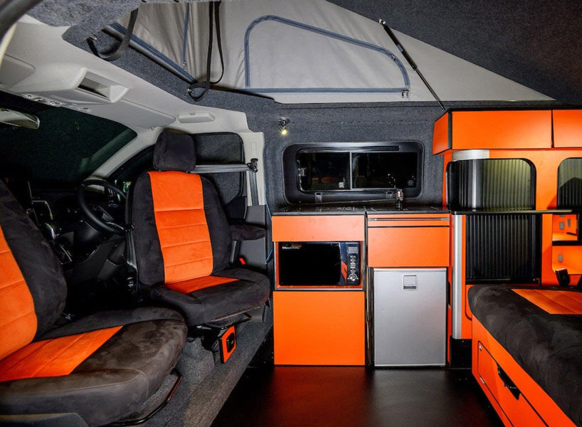 solar panels charge the new and spacious ford camper, making it fully electric