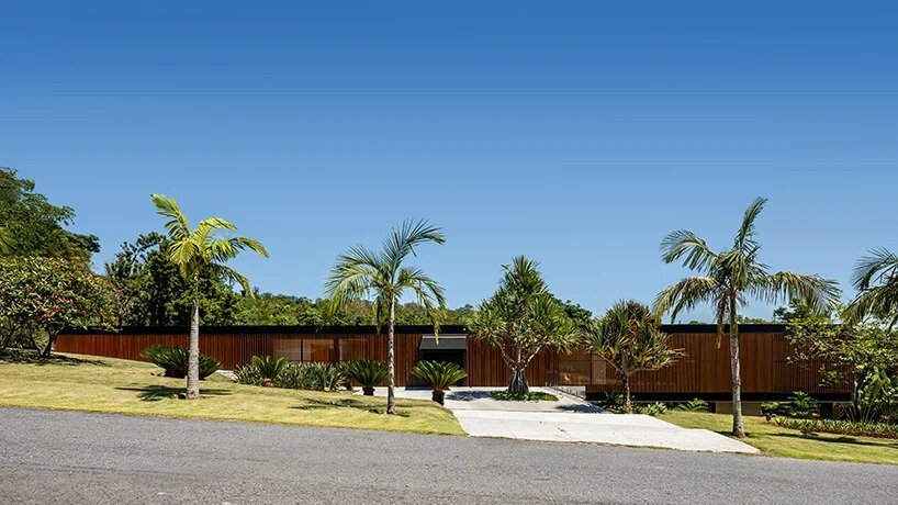 this 990 sqm house in são paulo is marked by two contrasting facades