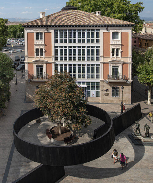 this installation cuts through a public square in spain with simple yet powerful gestures