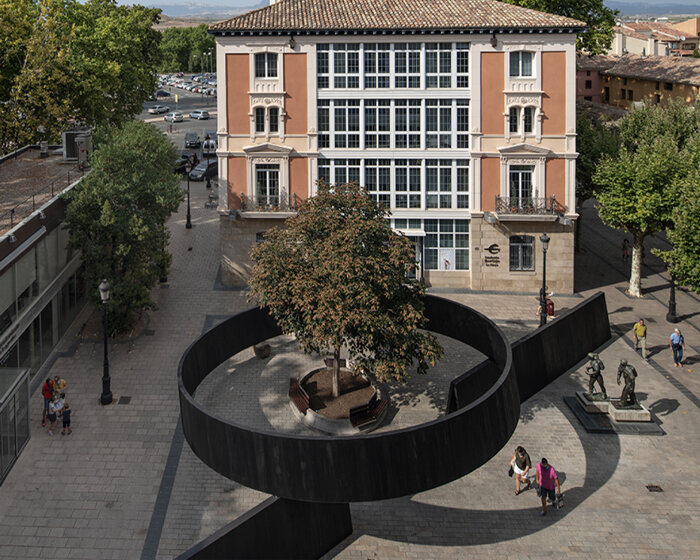 this installation cuts through a public square in spain with simple yet powerful gestures