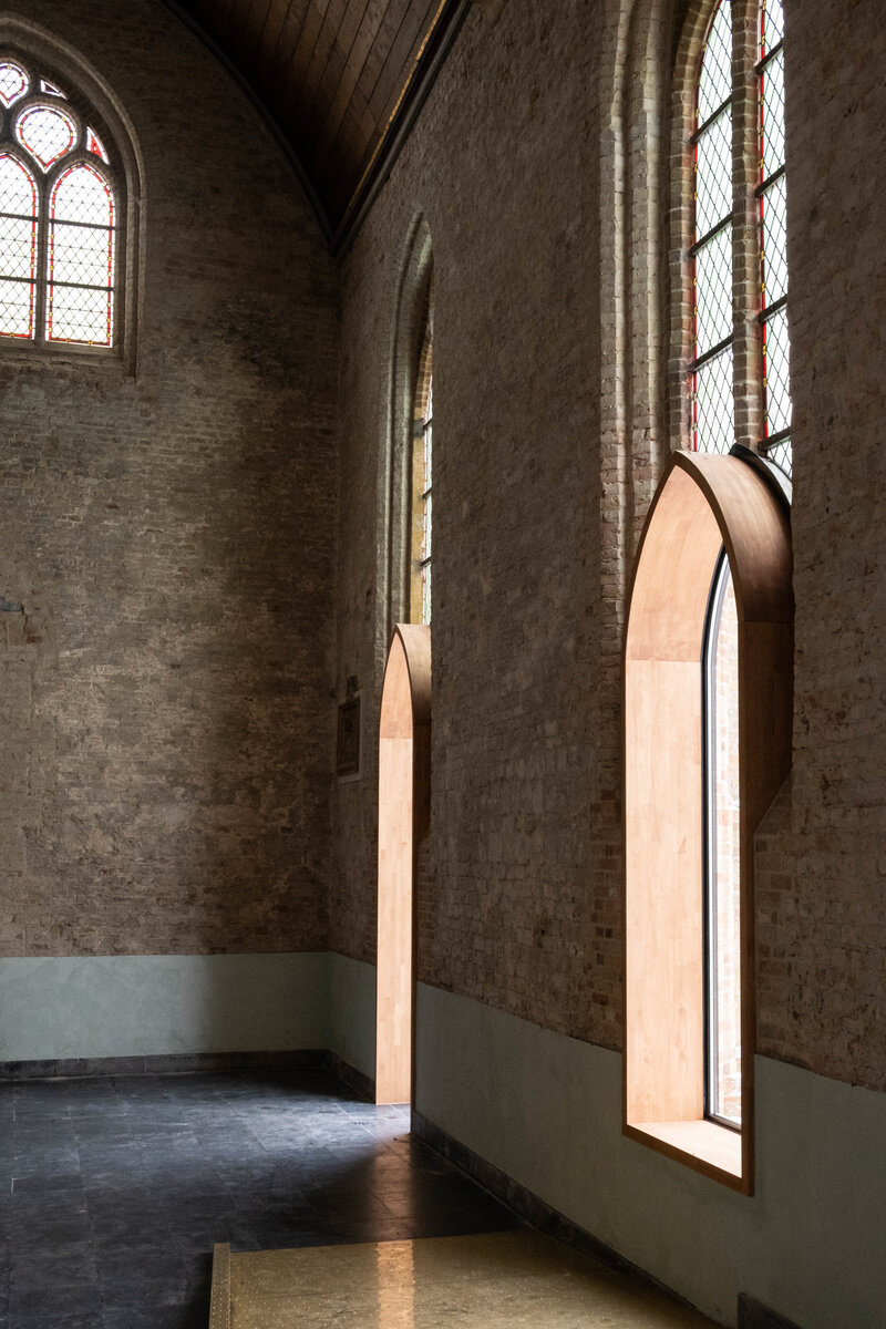 dhooge & meganck installs wooden 'house of silence' within renovated church in belgium