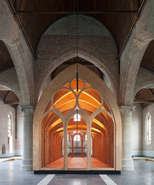 dhooge & meganck installs wooden 'house of silence' within renovated church in belgium