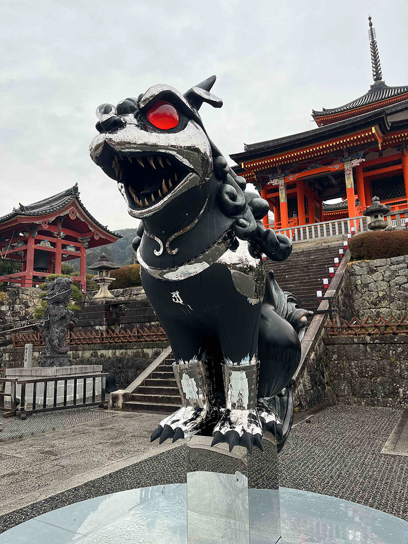 giant kokeshi doll welcomes visitors to historic kiyomizu-dera temple in kyoto