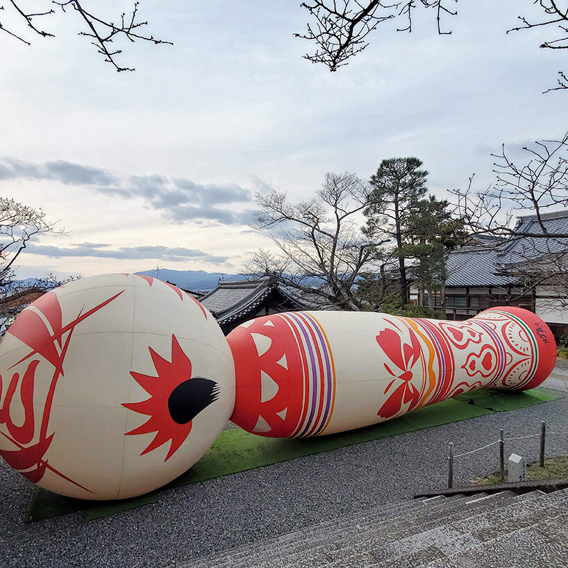 giant kokeshi doll welcomes visitors to historic kiyomizu-dera temple in kyoto