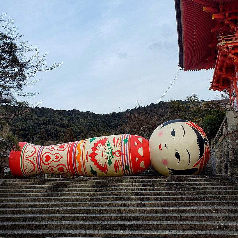 giant kokeshi doll welcomes visitors to historic kiyomizu-dera temple in kyoto