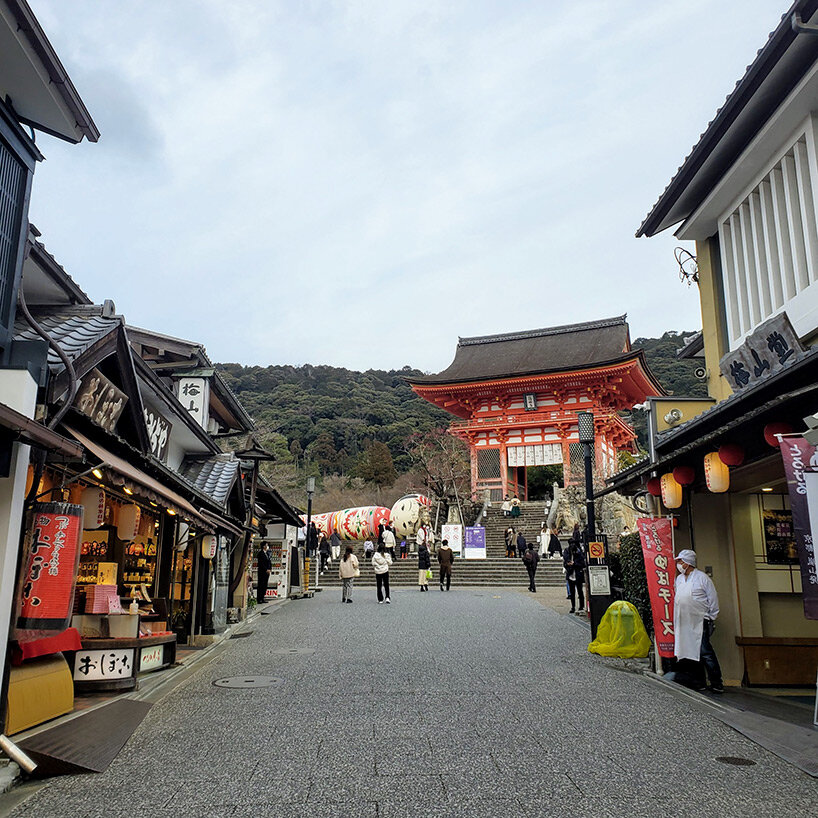 giant kokeshi doll welcomes visitors to historic kiyomizu-dera temple in kyoto