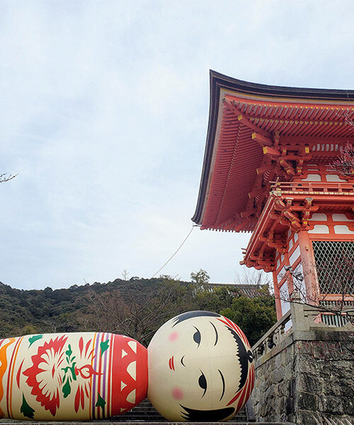 giant kokeshi doll welcomes visitors to historic kiyomizu-dera temple in kyoto