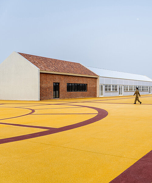 wutopia lab converts disused barnyard into golden yellow haven in shanghai