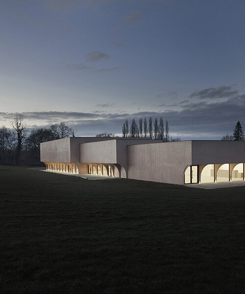 a series of half arches carve monolithic cultural center in france