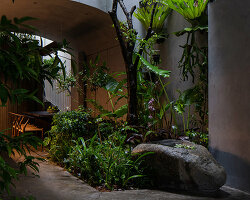 rear studio completes daylit vietnamese house with primitive design accents