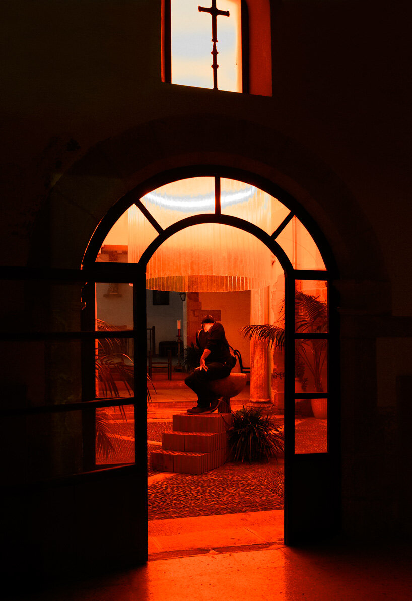 monumental lamp installation lights up the main patio of a 17th century monastery in spain