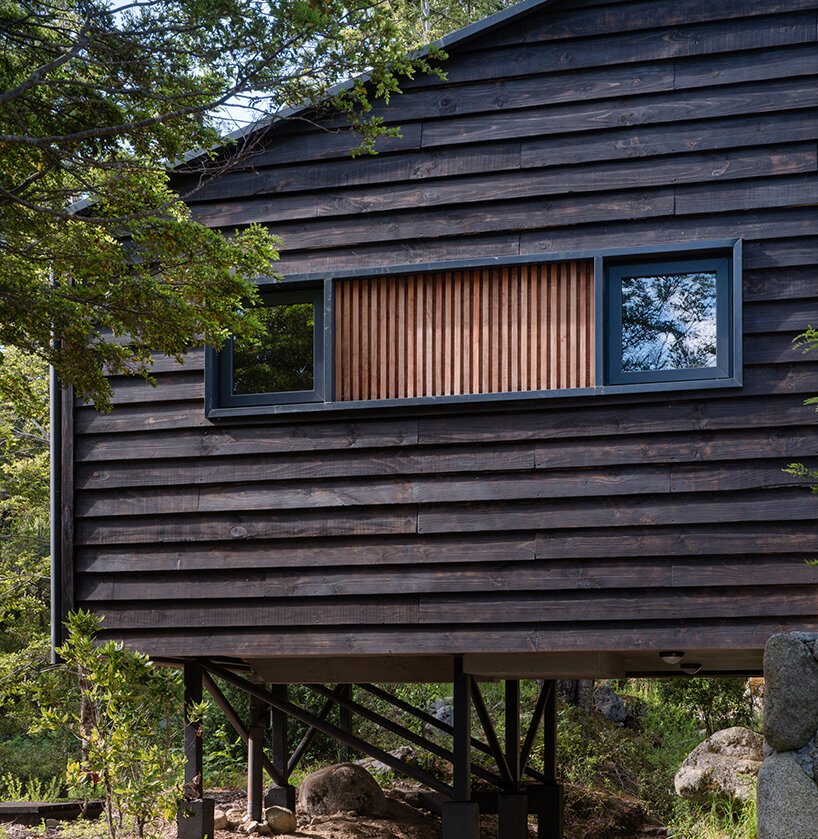 minimalistic cabin by hebra arquitectos emerges from a stone plinth in chile