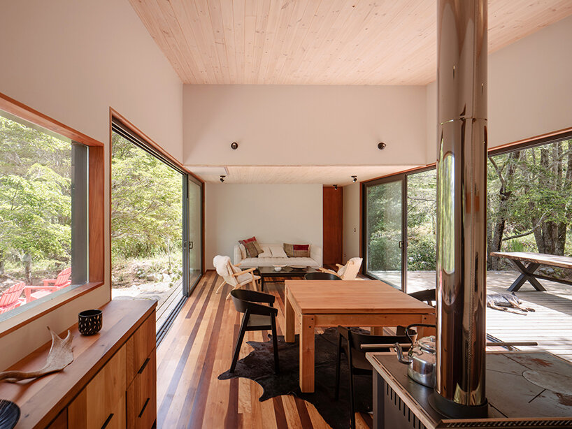 minimalistic cabin by hebra arquitectos emerges from a stone plinth in chile