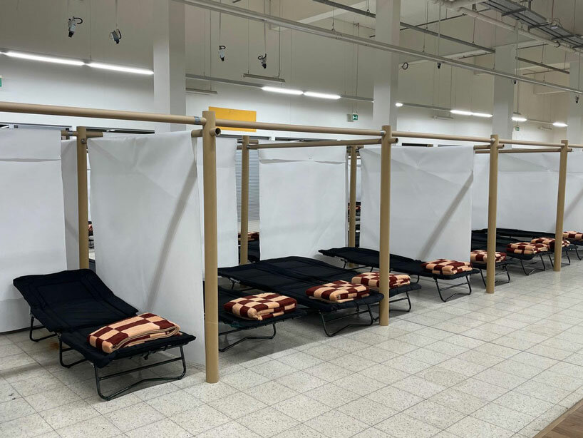 shigeru ban and VAN install paper partition shelters for ukrainian refugees in europe