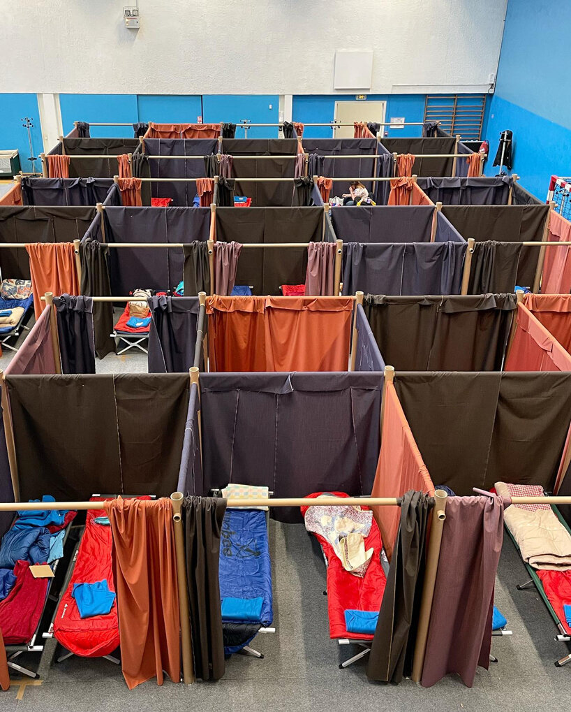 shigeru ban and VAN install paper partition shelters for ukrainian refugees in europe