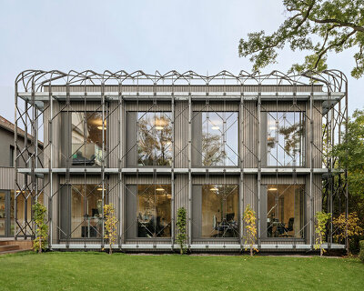 a shell for climbing plants wraps this timber office pavilion in vienna