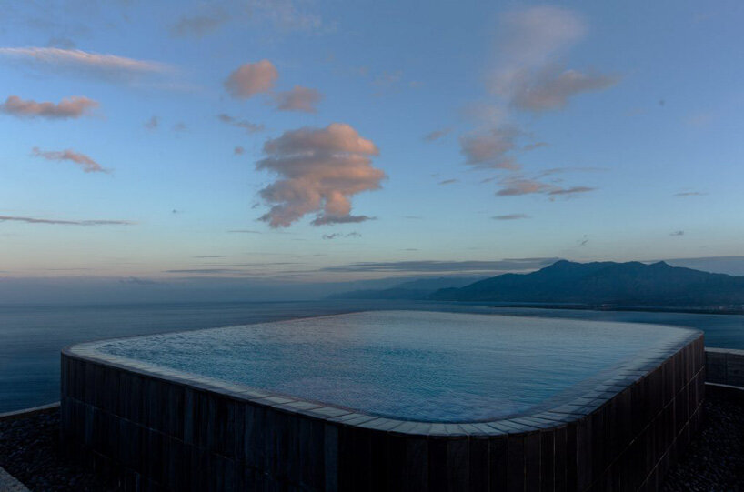 curvaceous concrete walls compose XRANGE architects' remote retreat in taiwan