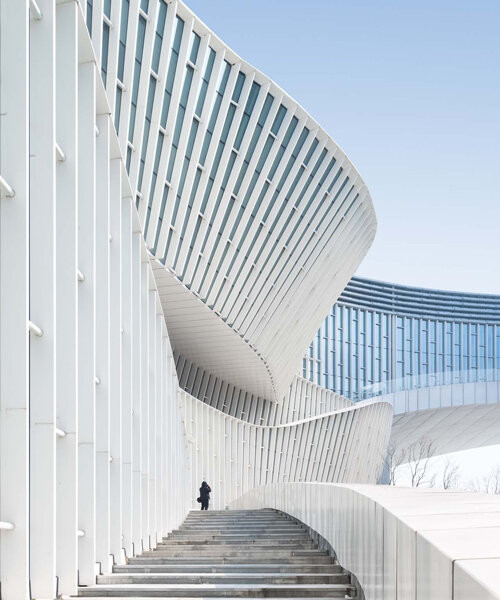 this undulating 'grand canal theater' by TJAD frames the lake of yangzhou