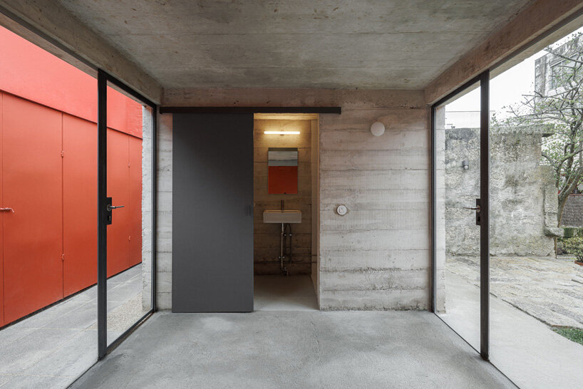 white concrete encloses josé pedro lima's bright red multi-use garden pavilion in portugal
