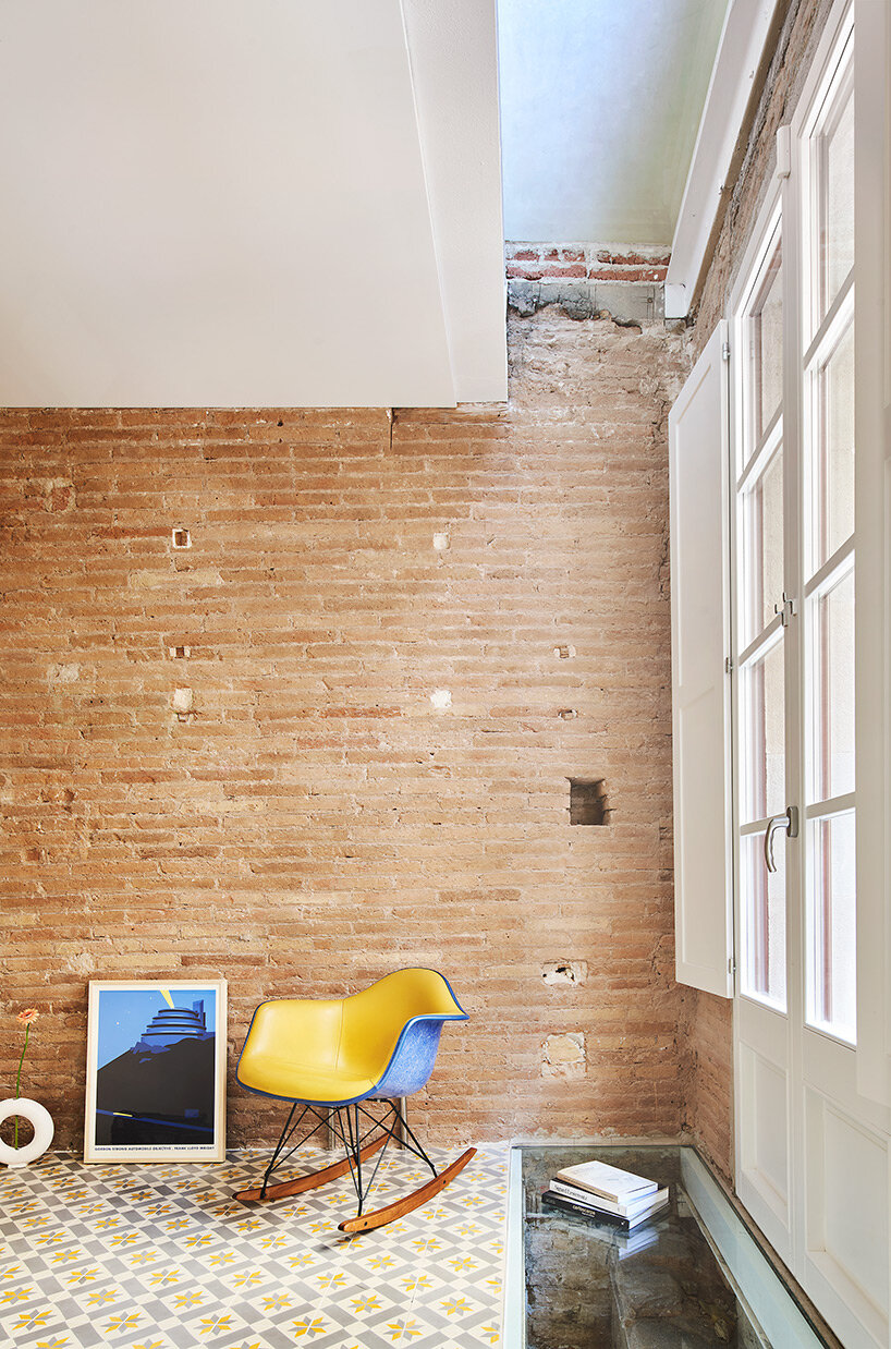 raúl sánchez adorns exposed brick interior with brass kitchen in renovated barcelona house