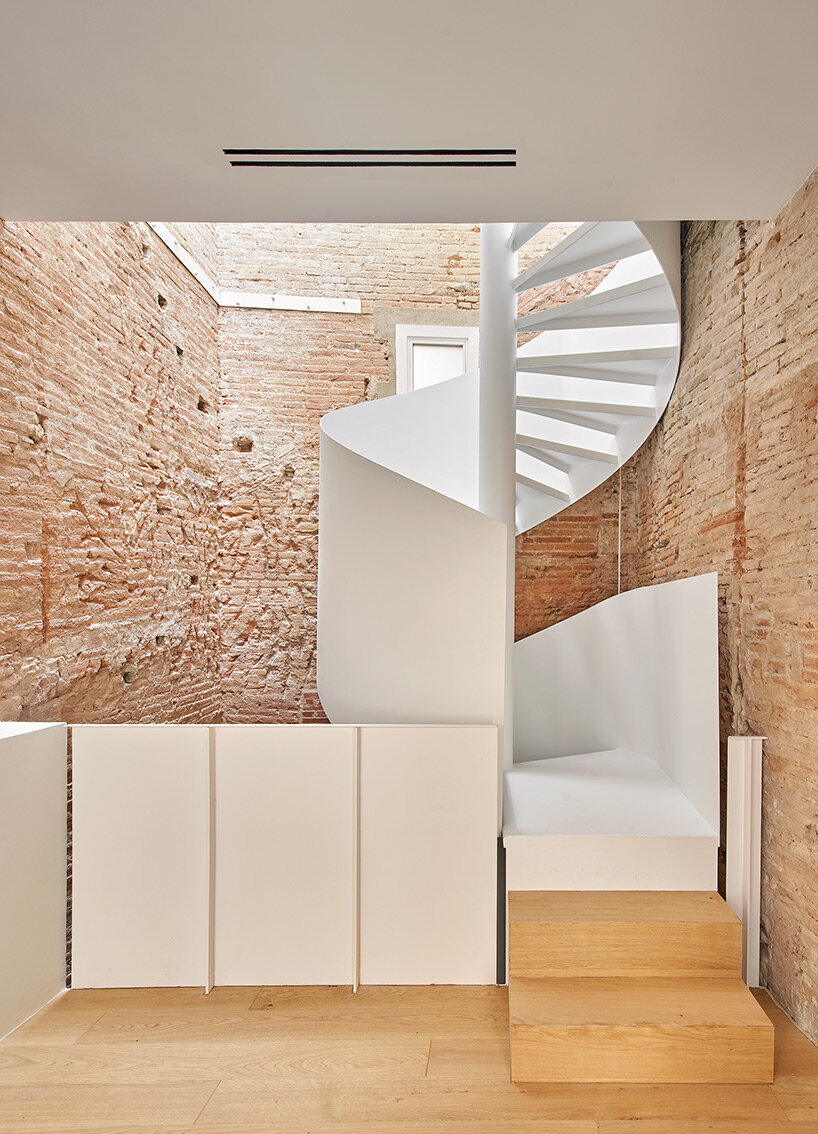 raúl sánchez adorns exposed brick interior with brass kitchen in renovated barcelona house