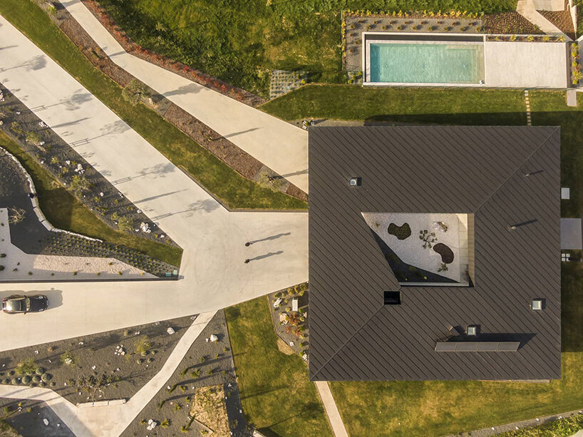 geometric central patio cuts through industrial concrete residence in portugal