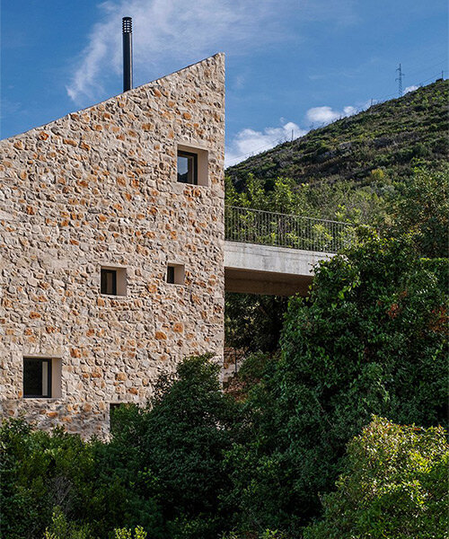 monolithic stone house by studio archaos emerges from verdant site on croatian island