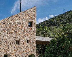 monolithic stone house by studio archaos emerges from verdant site on croatian island