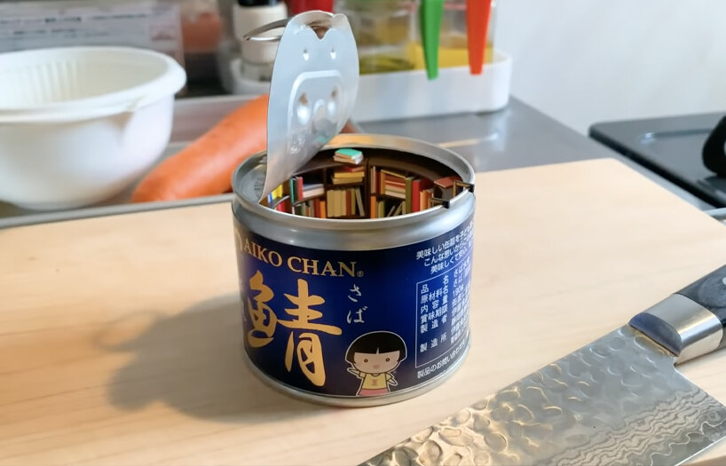 empty food can becomes portal to cozy, miniature reading room